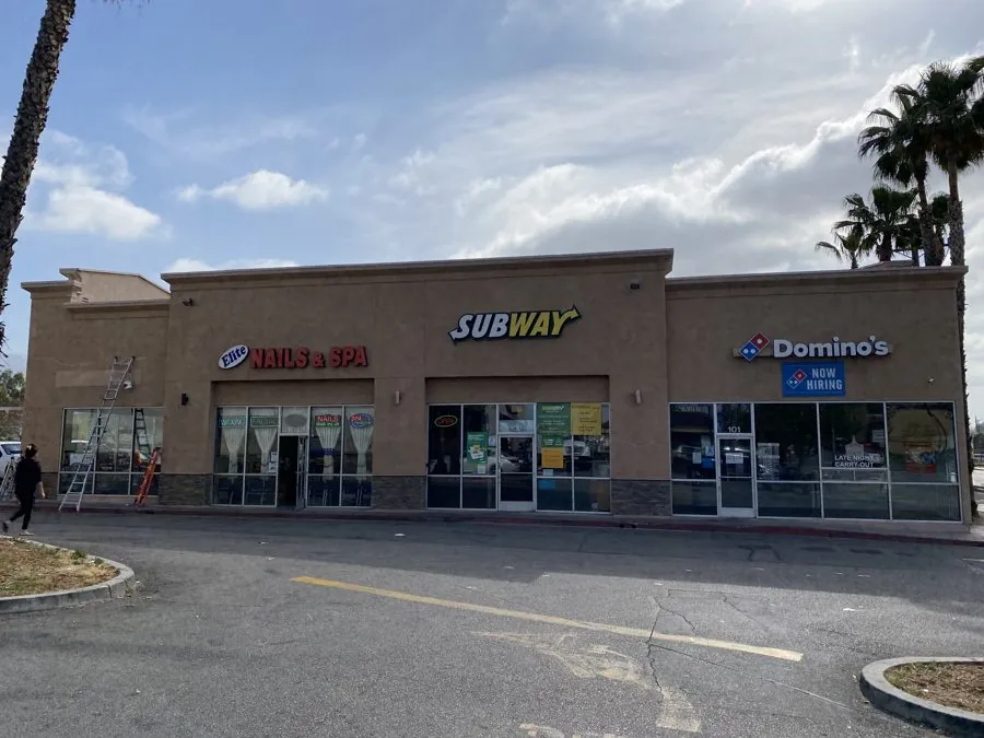 Multi-tenant retail center before exterior repaint