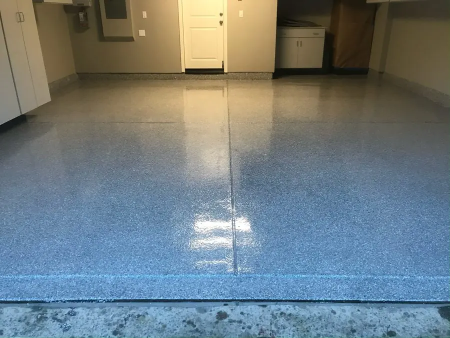 Blue Flake Garage — Full-broadcast flake system with a high-gloss clear coat over a ground slab.