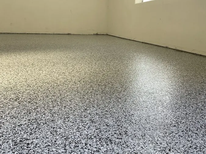 Black & White Flake — Two-car garage in a black, white and gray flake blend — hides dust and tire marks.