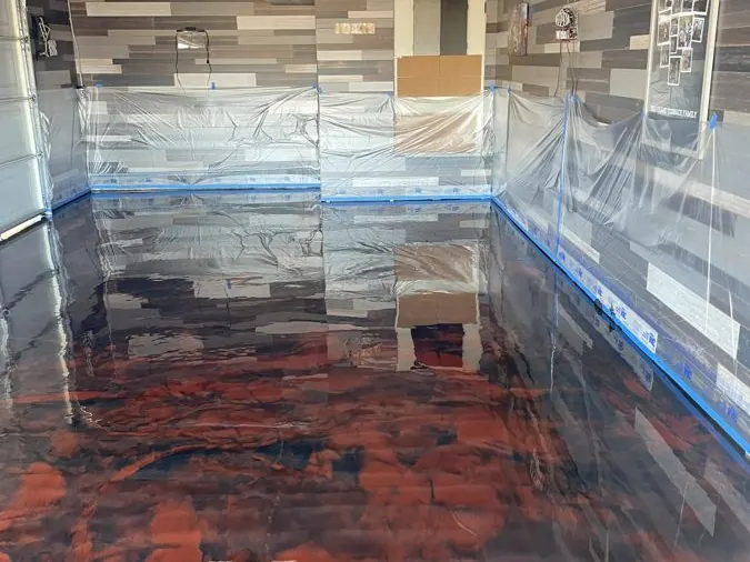 Copper Metallic Basement — Copper and black metallic epoxy poured across a finished basement floor.