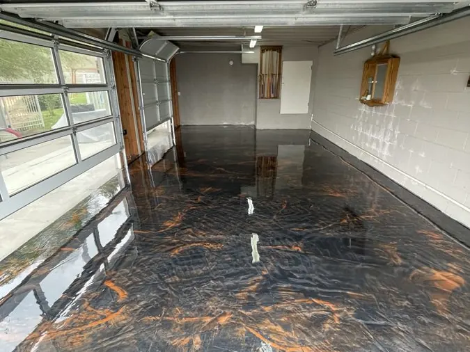 Metallic Garage Floor — Metallic system across a full two-car garage — a showroom look that still takes hot tires.