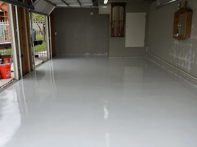 Solid Gray Epoxy — Clean single-color floor with a semi-gloss finish for a workshop garage.
