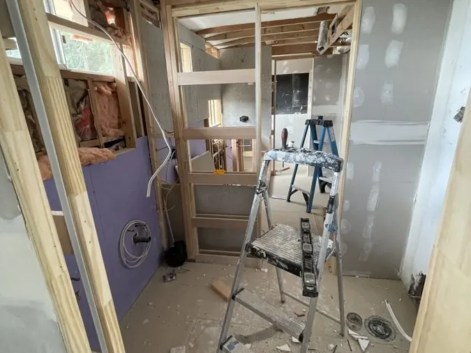 Full Bathroom Rebuild — New framing and moisture-resistant board going up after demolition.